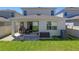 The home's backyard with an outdoor patio offers a great area for relaxation and entertaining with a grassy lawn at 4630 Cragmere Loop, Clermont, FL 34711