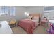 Charming bedroom featuring a pink-themed decor, cozy furnishings, and plenty of natural light at 4630 Cragmere Loop, Clermont, FL 34711
