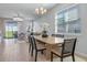 Bright dining room with a modern chandelier, tile floors, and backyard views at 4630 Cragmere Loop, Clermont, FL 34711