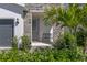 Inviting entryway with stone accents, lush landscaping, and a cozy bench at 4630 Cragmere Loop, Clermont, FL 34711