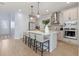 Open-concept kitchen featuring an island with bar seating and modern appliances at 4630 Cragmere Loop, Clermont, FL 34711
