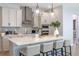 Modern kitchen with quartz countertops, stainless steel appliances, and pendant lighting at 4630 Cragmere Loop, Clermont, FL 34711