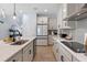 Bright and airy kitchen featuring white cabinets, a gray backsplash, and a center island at 4630 Cragmere Loop, Clermont, FL 34711