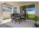 A covered patio provides an excellent outdoor dining spot, complete with a grill and a view of the green lawn at 4630 Cragmere Loop, Clermont, FL 34711