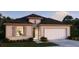Charming single-story home featuring a two-car garage, neutral color palette, and well-maintained landscaping at 4895 Lyric Dr, Mascotte, FL 34753