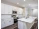 Bright kitchen features white cabinets, stainless steel appliances and a large island at 4895 Lyric Dr, Mascotte, FL 34753