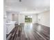 Bright, open living space featuring wood floors and sliding doors to the backyard at 4895 Lyric Dr, Mascotte, FL 34753