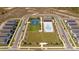 Aerial view of a community pool, tennis courts, and green space in a new neighborhood at 4994 Citrus Leaf Blvd, Winter Garden, FL 34787