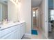 Bathroom featuring a dual sink vanity, an en-suite shower, and tile flooring at 4994 Citrus Leaf Blvd, Winter Garden, FL 34787