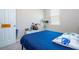 This bedroom has a large window, white trim, and a blue comforter at 4994 Citrus Leaf Blvd, Winter Garden, FL 34787