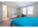 Bright bedroom featuring carpet, two windows, a desk, and an en-suite bathroom at 4994 Citrus Leaf Blvd, Winter Garden, FL 34787