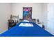 Bright bedroom featuring a blue comforter, window for natural light, and desk with a chair at 4994 Citrus Leaf Blvd, Winter Garden, FL 34787