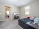 Comfortable bedroom featuring soft carpet, a window letting in natural light and a nice entertainment center with television at 4994 Citrus Leaf Blvd, Winter Garden, FL 34787