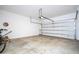 Open garage space showcasing a bicycle, and partial garage door view at 4994 Citrus Leaf Blvd, Winter Garden, FL 34787