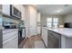 Bright kitchen features white cabinets, stainless steel appliances, and a large island, creating a modern and functional space at 4994 Citrus Leaf Blvd, Winter Garden, FL 34787