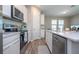 Bright kitchen features white cabinets, stainless steel appliances, and a large island, creating a modern and functional space at 4994 Citrus Leaf Blvd, Winter Garden, FL 34787