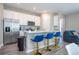 Well-equipped kitchen with stainless steel appliances, island with seating, and adjacent living area, ideal for modern living at 4994 Citrus Leaf Blvd, Winter Garden, FL 34787
