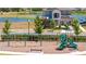 A playground with slides and swings sit in front of a lake and newer home at 4994 Citrus Leaf Blvd, Winter Garden, FL 34787