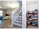 View of a living room with staircase and safety gate, plus shoe rack at 4994 Citrus Leaf Blvd, Winter Garden, FL 34787