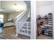 View of a living room with staircase and safety gate, plus shoe rack at 4994 Citrus Leaf Blvd, Winter Garden, FL 34787