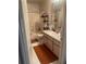 This bathroom has a shower/tub combo, vanity, and orange bath mat at 5471 Vineland Rd # 7108, Orlando, FL 32811