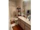 This bathroom has a shower/tub combo, vanity, and orange bath mat at 5471 Vineland Rd # 7108, Orlando, FL 32811
