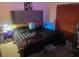 Comfortable bedroom featuring a bed with a headboard and side tables at 5471 Vineland Rd # 7108, Orlando, FL 32811