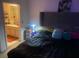 Comfortable bedroom featuring a bed with a headboard and ensuite bathroom at 5471 Vineland Rd # 7108, Orlando, FL 32811