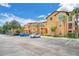 Beautiful two-story condo building featuring a parking lot and lush landscaping at 5471 Vineland Rd # 7108, Orlando, FL 32811