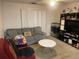 Cozy living room with a sofa, armchair and entertainment center at 5471 Vineland Rd # 7108, Orlando, FL 32811