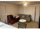 Cozy living room with a sofa and armchair near natural light from sliding glass doors at 5471 Vineland Rd # 7108, Orlando, FL 32811