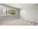 Bright bedroom with a window and gray carpet flooring at 6114 Peregrine Ave # D03, Orlando, FL 32819