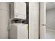 A tidy laundry area features a stacked washer and dryer along with added storage space at 6114 Peregrine Ave # D03, Orlando, FL 32819
