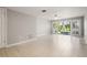 Spacious living room featuring tile flooring, a ceiling fan, and sliding glass doors to the outdoor area at 6114 Peregrine Ave # D03, Orlando, FL 32819