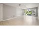 Bright living room with sliding doors, ceramic tile flooring and view of the canal at 6114 Peregrine Ave # D03, Orlando, FL 32819