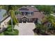 An aerial view shows the house's roof and solar panels, the brick driveway, and the front yard landscaping at 7299 Vista Park Blvd, Orlando, FL 32829