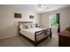 Comfortable bedroom with a wrought iron bed frame, soft carpeting, and a bright window view at 7299 Vista Park Blvd, Orlando, FL 32829