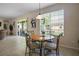 Bright breakfast nook with tile flooring features a round table set with four chairs and access to patio at 7299 Vista Park Blvd, Orlando, FL 32829