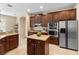 Well-equipped kitchen features a center island, stainless steel appliances and dark wood cabinetry at 7299 Vista Park Blvd, Orlando, FL 32829