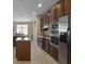 A modern kitchen with stainless steel appliances, a center island, and stylish dark wood cabinetry at 7299 Vista Park Blvd, Orlando, FL 32829