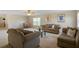 Comfortable living room featuring neutral tones, plush seating, and a ceiling fan at 7299 Vista Park Blvd, Orlando, FL 32829