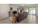 Bright living room with glass sliding doors, a cozy couch, and tile flooring throughout at 7299 Vista Park Blvd, Orlando, FL 32829