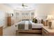 Bright main bedroom featuring tray ceiling, neutral carpet, and a sitting area next to large windows at 7299 Vista Park Blvd, Orlando, FL 32829