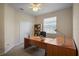 Cozy office space with built-in shelves, ceiling fan and a large window for natural light at 7299 Vista Park Blvd, Orlando, FL 32829