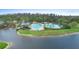 Aerial view of resort-style pool with lake and lush landscaping, offering a luxurious outdoor experience at 7299 Vista Park Blvd, Orlando, FL 32829