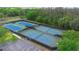 Overhead view of four well-maintained tennis courts with adjacent parking, promising an active lifestyle at 7299 Vista Park Blvd, Orlando, FL 32829