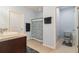 Light and airy bathroom features a shower, toilet and dark wood cabinets for storage and organization at 9731 Pepper Tree Trl, Wildwood, FL 34785