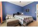 This bedroom has a ceiling fan, a chair and a window that lets in natural light at 9731 Pepper Tree Trl, Wildwood, FL 34785