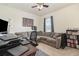 This bedroom has a TV, a couch and a window that lets in natural light at 9731 Pepper Tree Trl, Wildwood, FL 34785