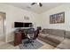 This bedroom has a desk, two TVs, a couch and a window that lets in natural light at 9731 Pepper Tree Trl, Wildwood, FL 34785